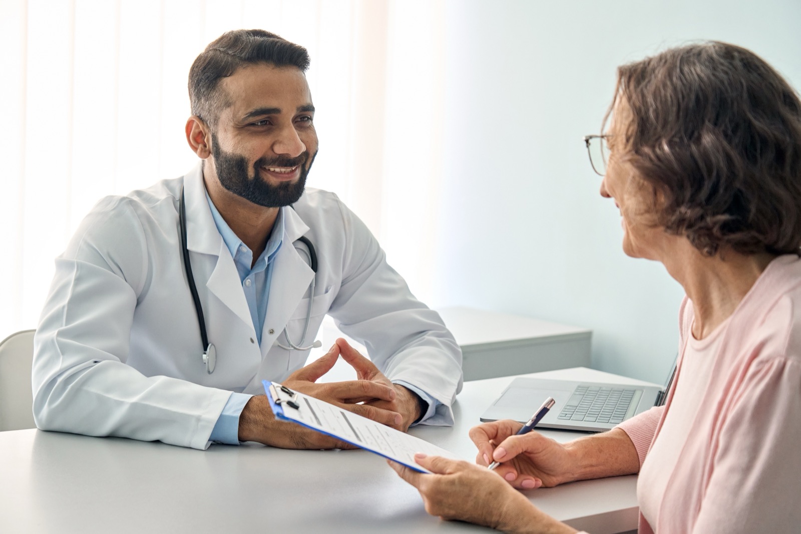 Male doctor consulting female patient during a check up
appointment.